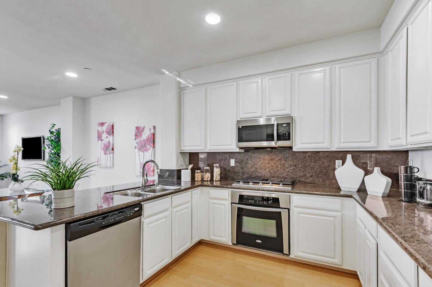 1142 Mente Linda Loop Milpitas, CA 95035 - Photo 9 of 36 a kitchen with stainless steel appliances granite countertop a sink a stove and cabinets