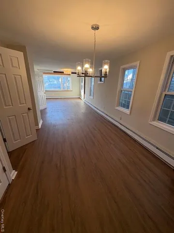 a view of a room with wooden floor