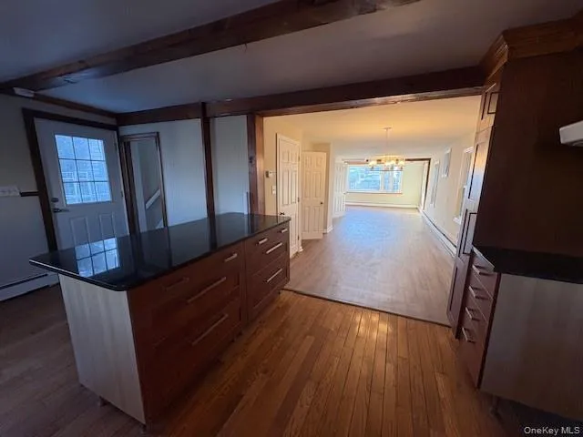 a view of hallway with wooden floor