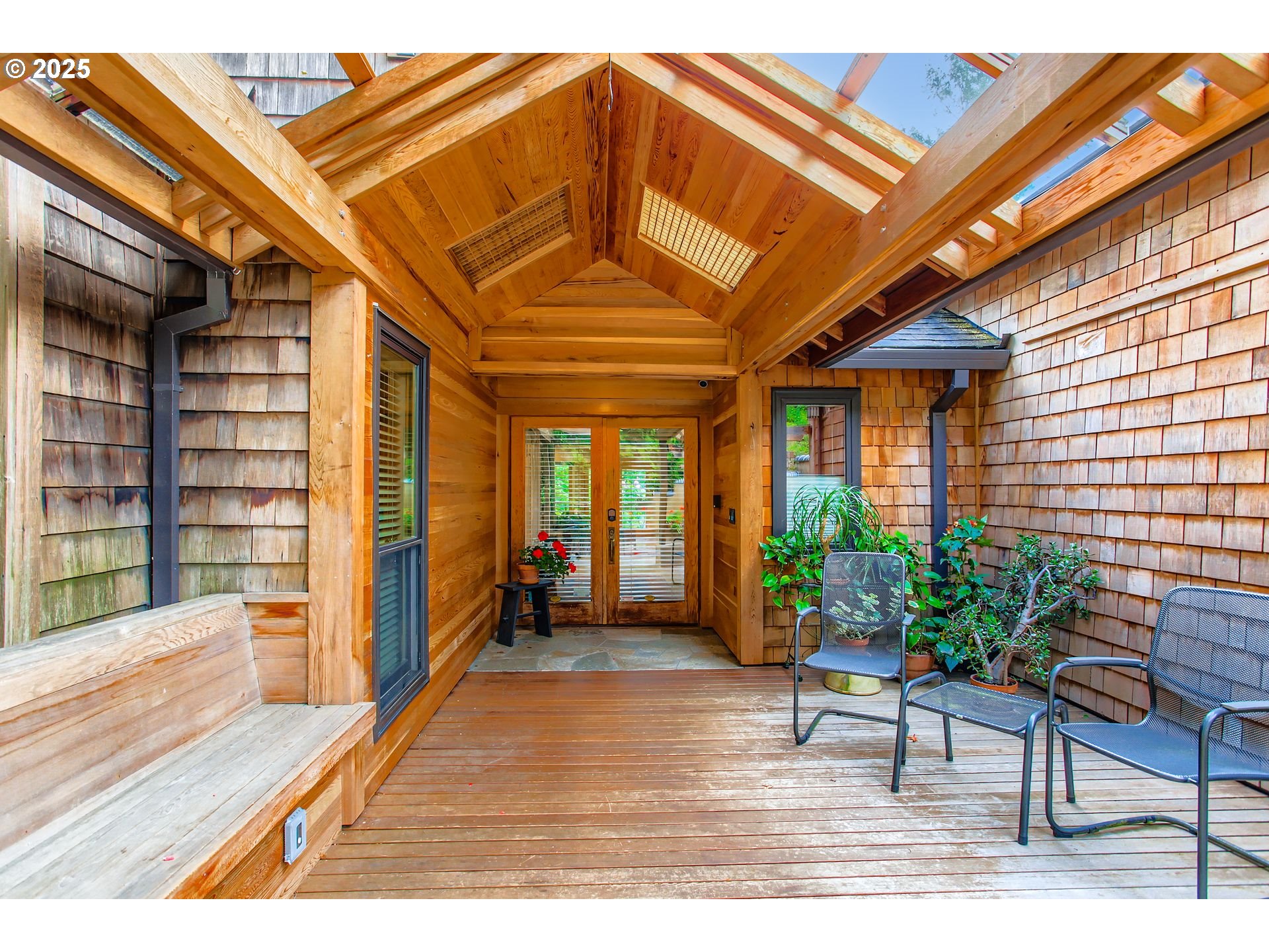 a hallway with a bench and wooden floor