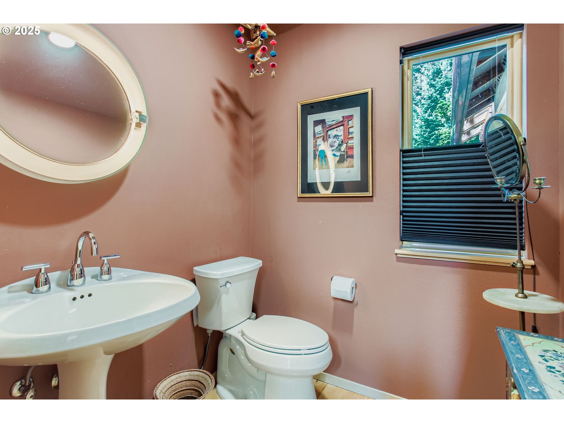3902 Southwest Mt Adams Drive Portland, OR 97239 - Photo 13 of 38 a bathroom with a sink a toilet and a mirror