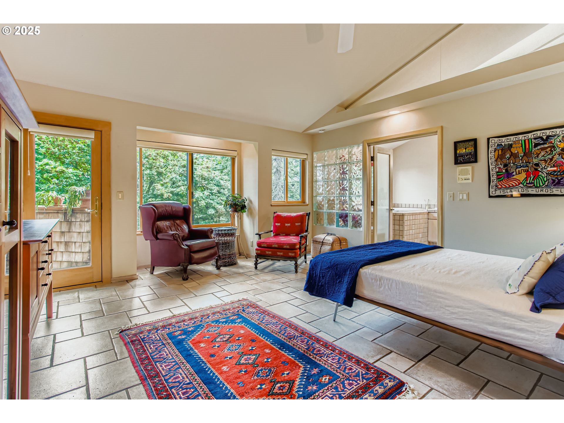 3902 Southwest Mt Adams Drive Portland, OR 97239 - Photo 14 of 38 a bedroom with a bed a couch and large window