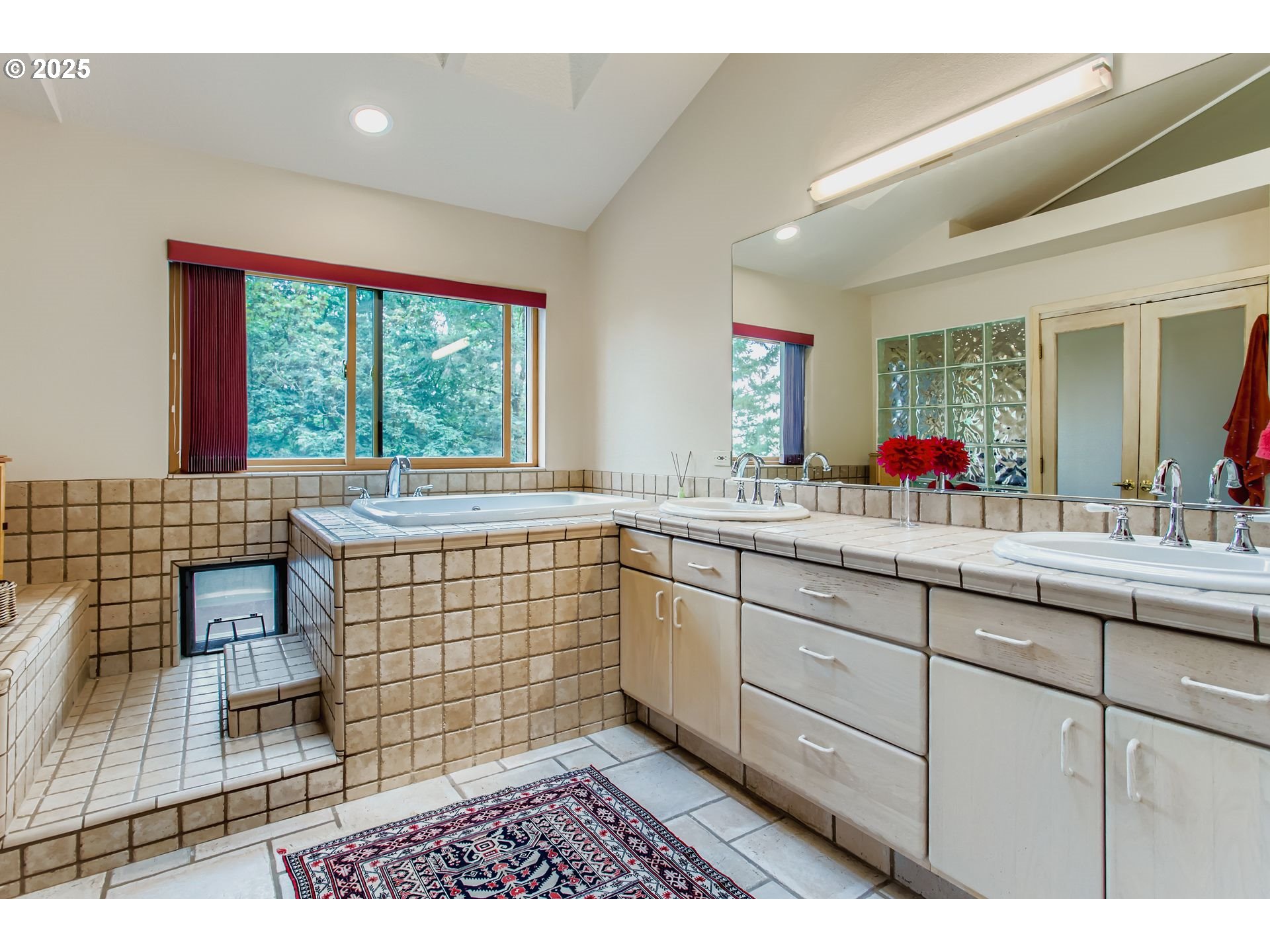 3902 Southwest Mt Adams Drive Portland, OR 97239 - Photo 16 of 38 a bathroom with a sink a mirror and a shower