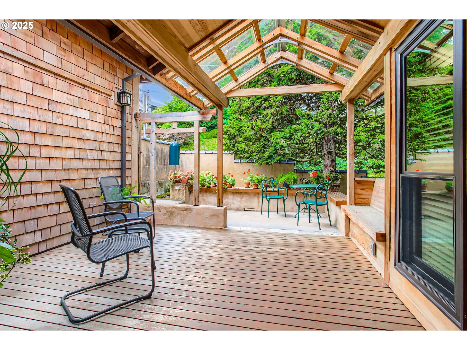 3902 Southwest Mt Adams Drive Portland, OR 97239 - Photo 2 of 38 a view of a patio with a dining table and chairs