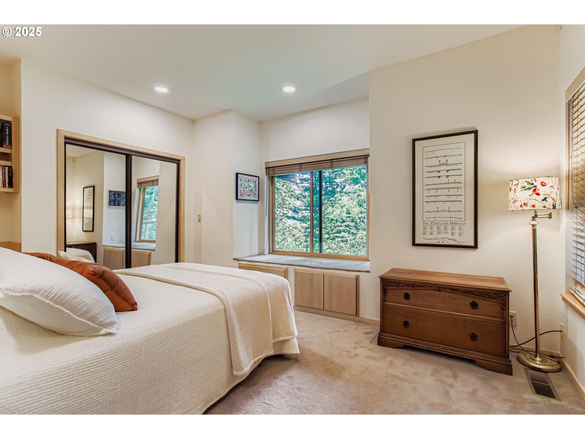 3902 Southwest Mt Adams Drive Portland, OR 97239 - Photo 21 of 38 a spacious bedroom with a bed and a window