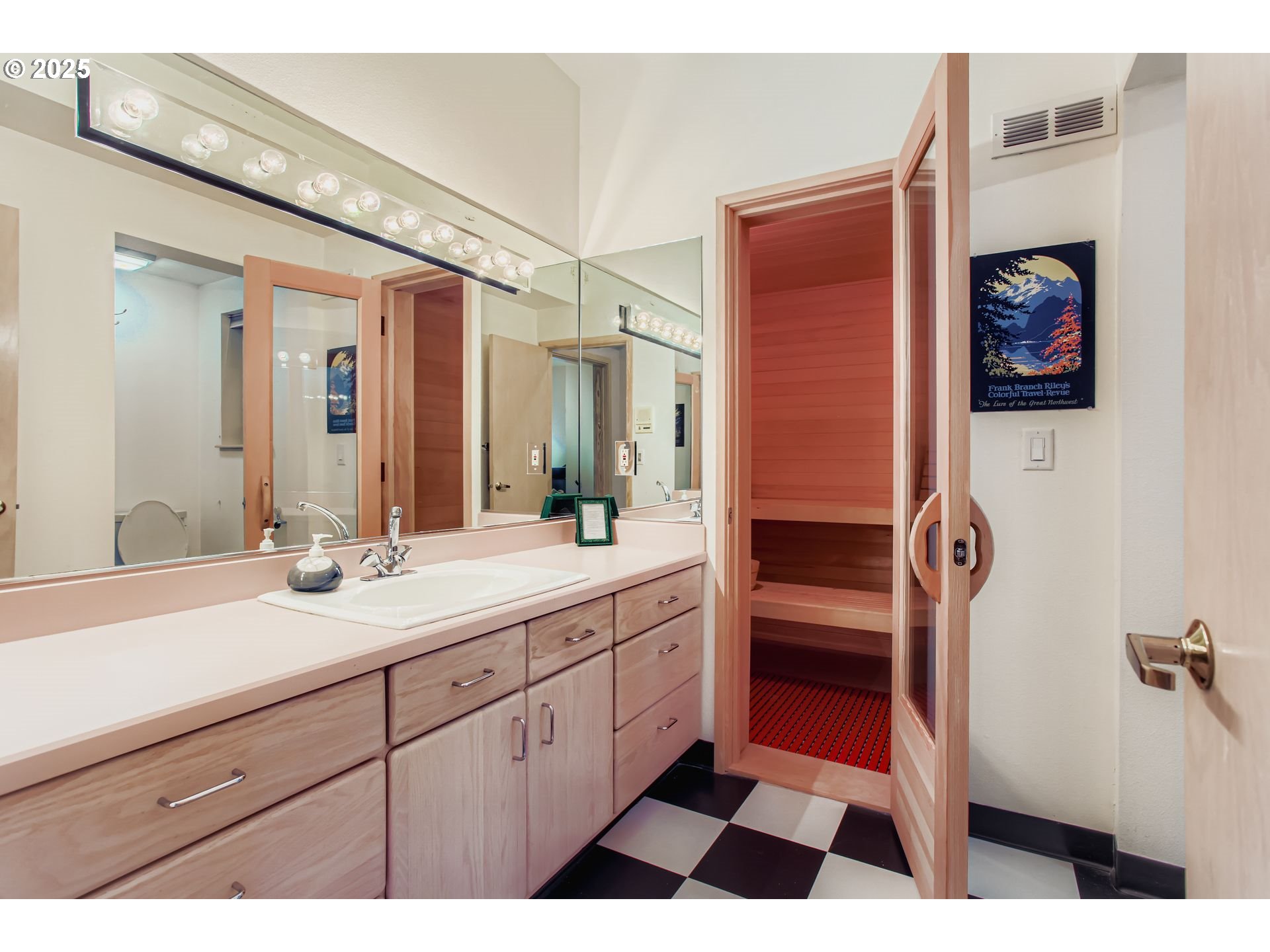 3902 Southwest Mt Adams Drive Portland, OR 97239 - Photo 22 of 38 a en suite bathroom with a sink a vanity and a mirror