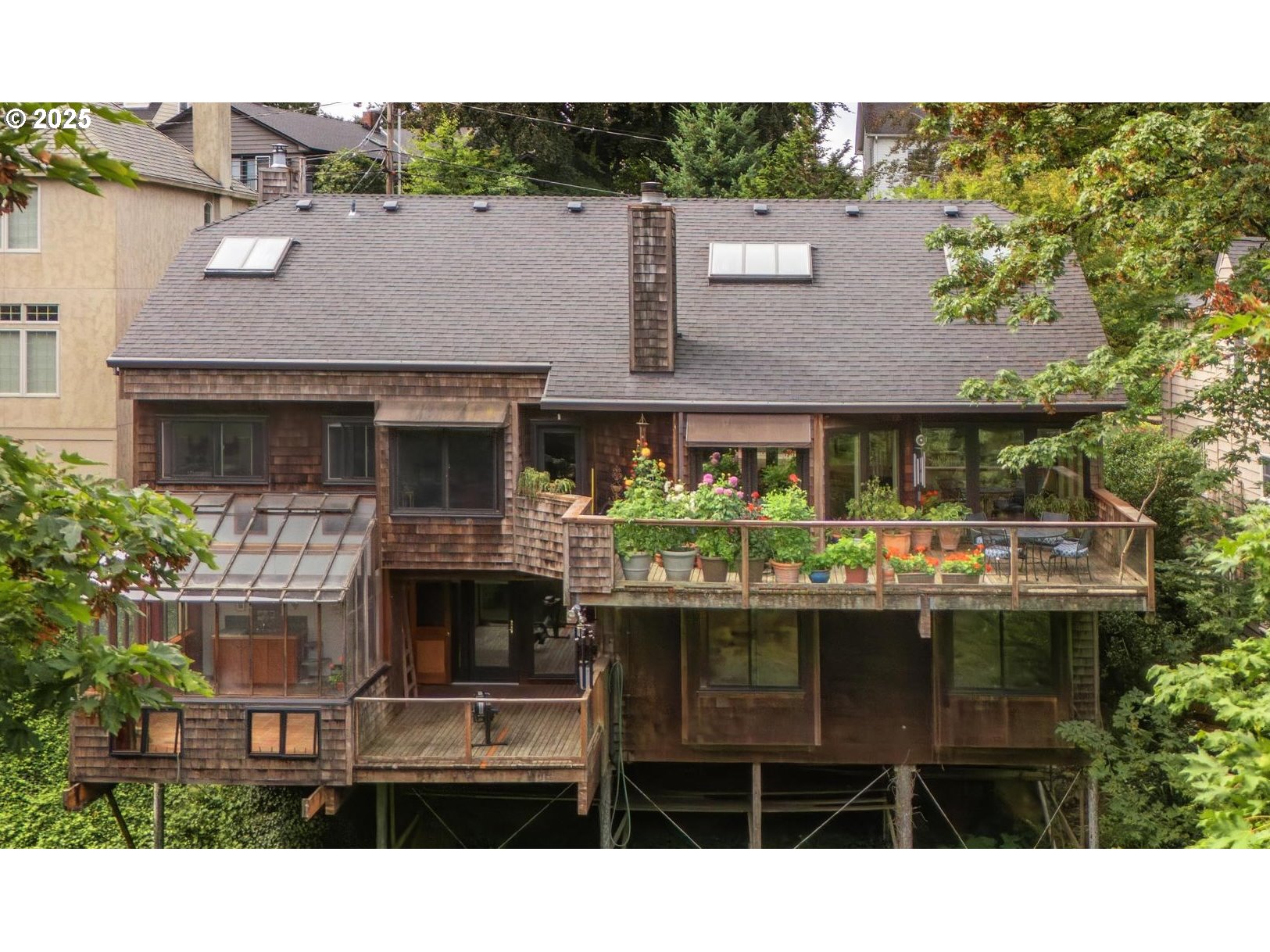 3902 Southwest Mt Adams Drive Portland, OR 97239 - Photo 27 of 38 a view of house with outdoor space and a car park