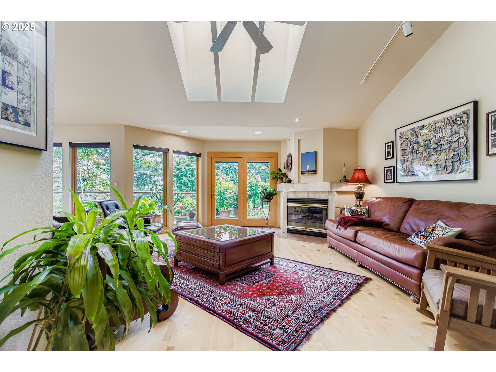 3902 Southwest Mt Adams Drive Portland, OR 97239 - Photo 5 of 38 a living room with furniture a large window and a fireplace
