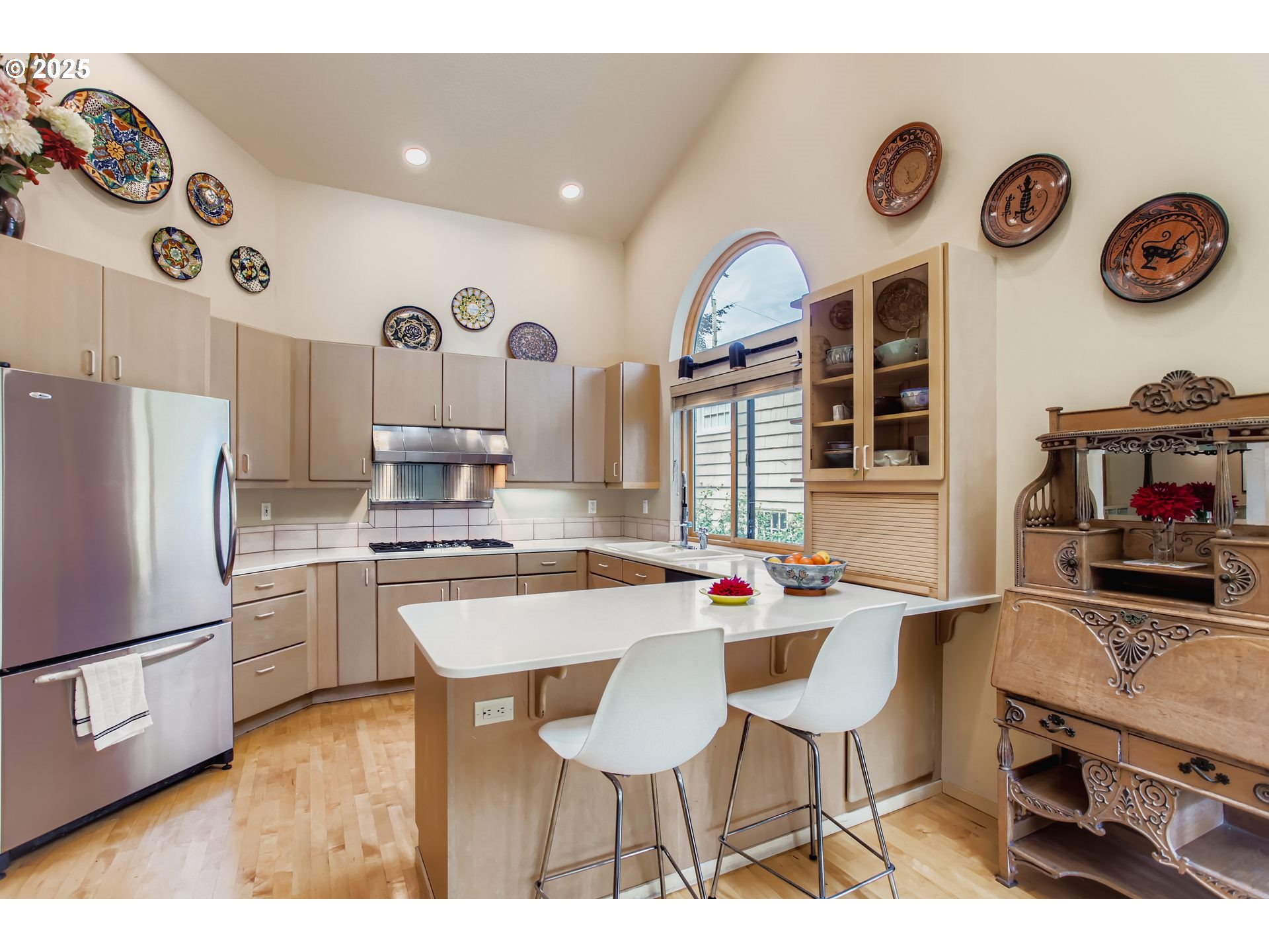 3902 Southwest Mt Adams Drive Portland, OR 97239 - Photo 6 of 38 a kitchen with stainless steel appliances a stove a refrigerator a sink and a refrigerator