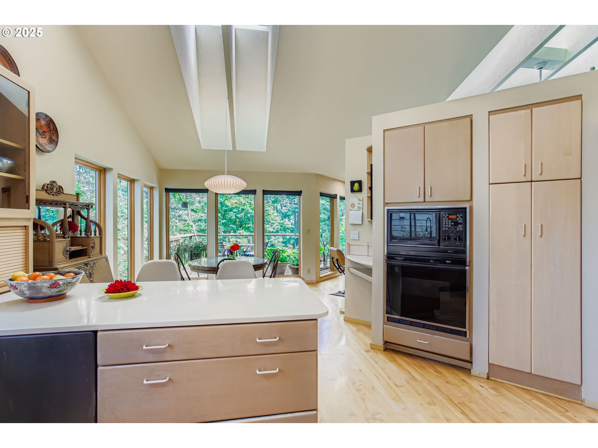 3902 Southwest Mt Adams Drive Portland, OR 97239 - Photo 8 of 38 a kitchen with stainless steel appliances kitchen island granite countertop a refrigerator and a sink