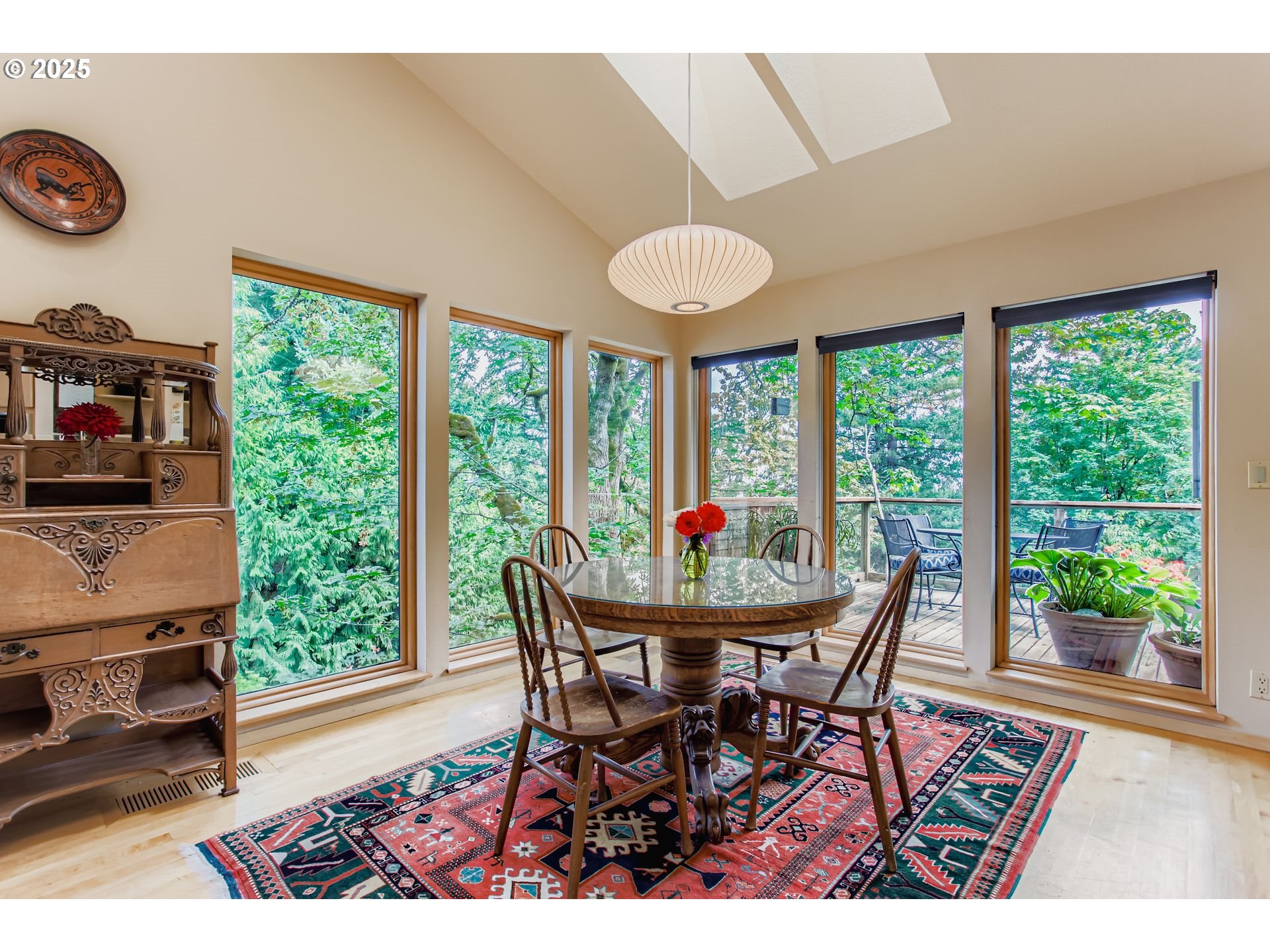 3902 Southwest Mt Adams Drive Portland, OR 97239 - Photo 9 of 38 a dining room with furniture and a floor to ceiling window