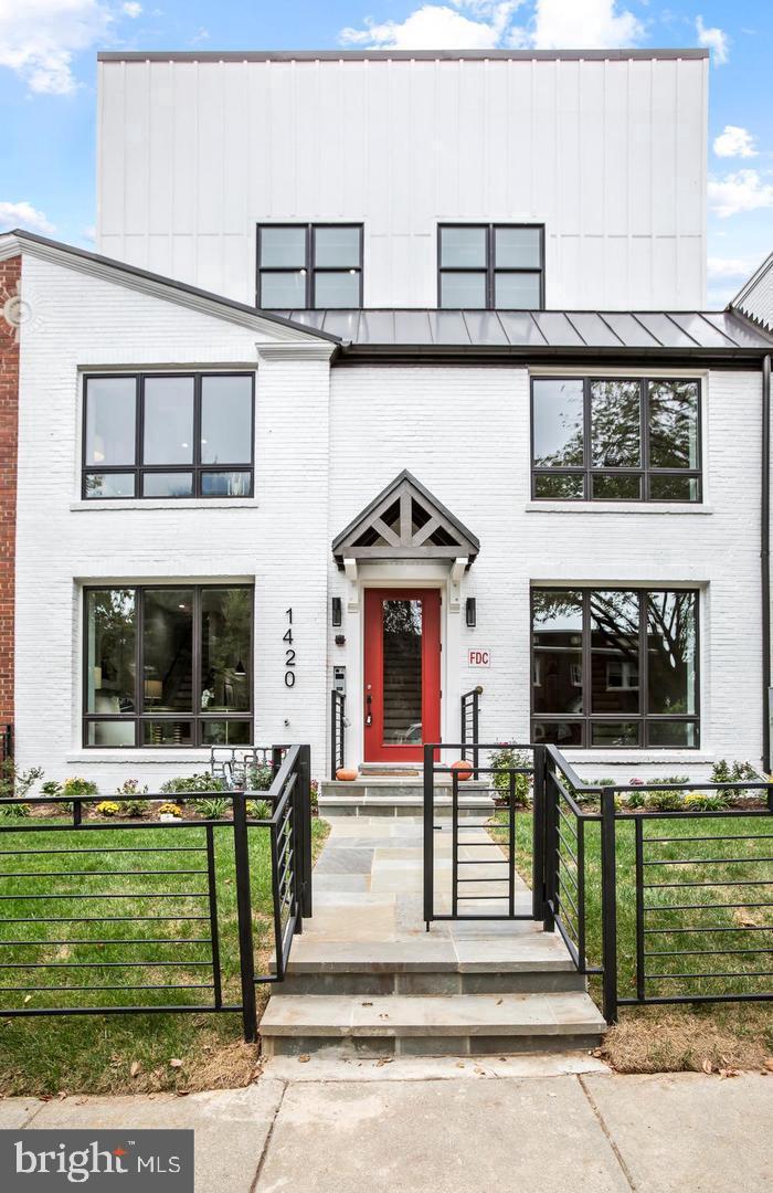 1420 Staples Street Northeast, Unit 2 Washington, DC 20002 - Photo 1 of 17 a front view of a house with a small yard
