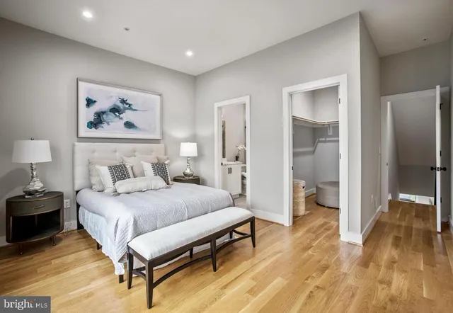 a bedroom with a bed and a painting on the wall