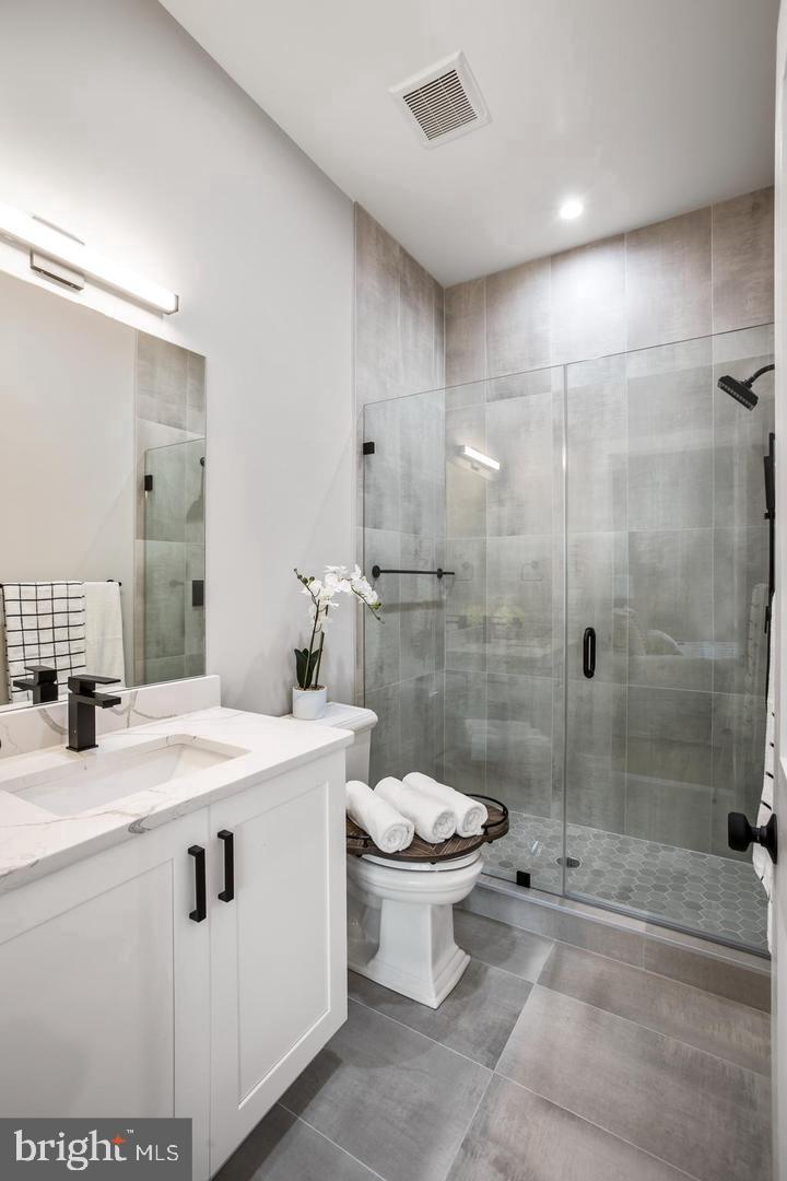 1420 Staples Street Northeast, Unit 2 Washington, DC 20002 - Photo 15 of 17 a bathroom with a sink toilet and shower