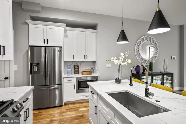 a kitchen with a stove a refrigerator and a sink