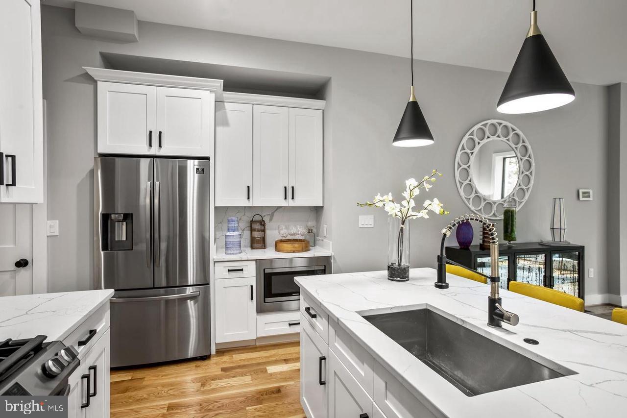 1420 Staples Street Northeast, Unit 2 Washington, DC 20002 - Photo 6 of 17 a kitchen with a stove a refrigerator and a sink