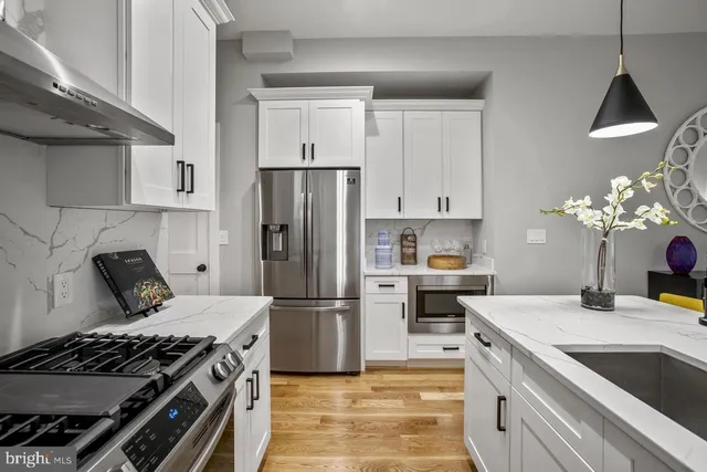 a kitchen with a stove and a refrigerator