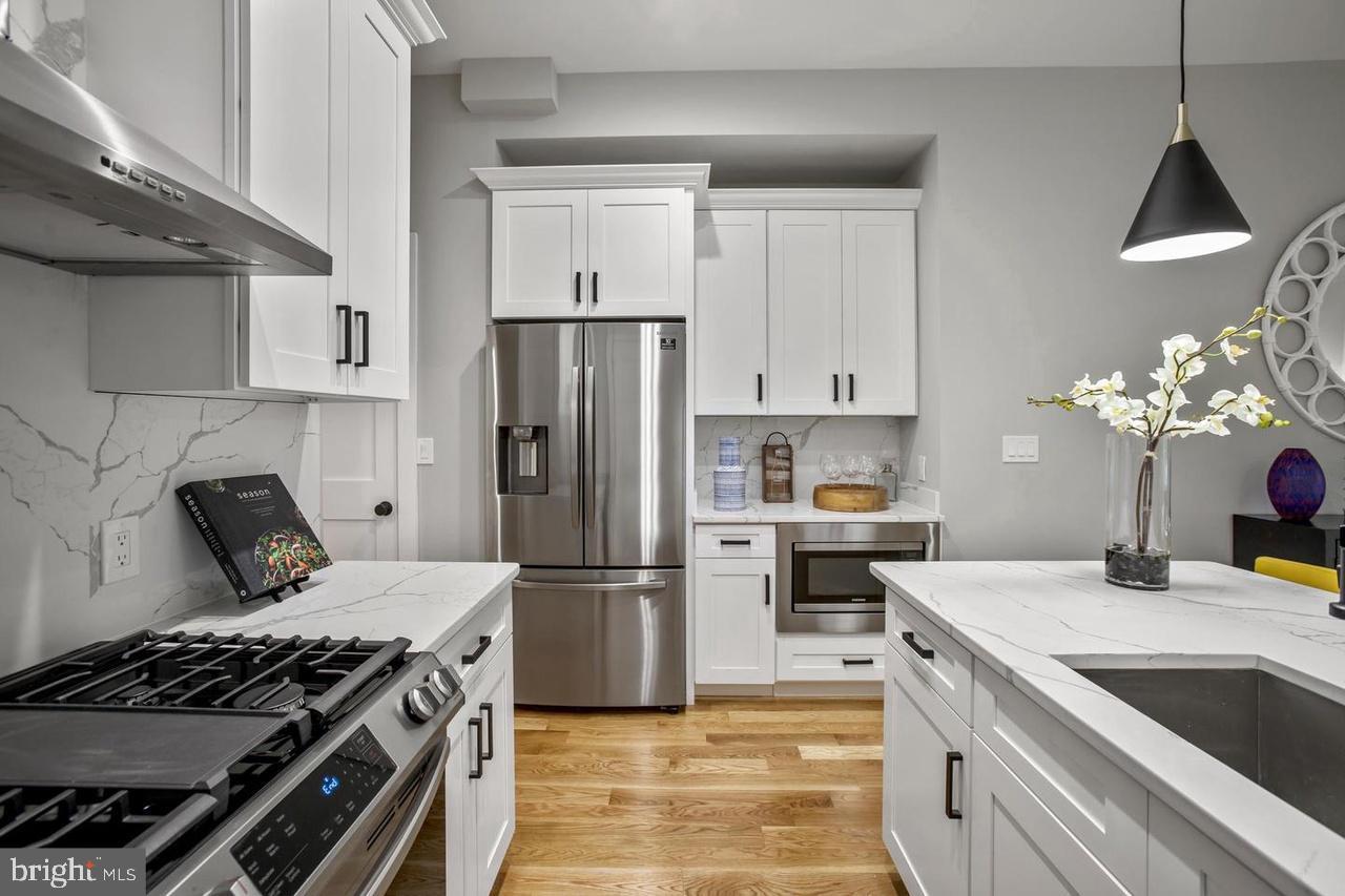 1420 Staples Street Northeast, Unit 2 Washington, DC 20002 - Photo 7 of 17 a kitchen with a stove and a refrigerator