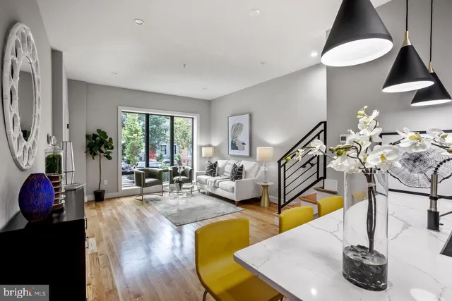 a living room with furniture gym equipment and a large window