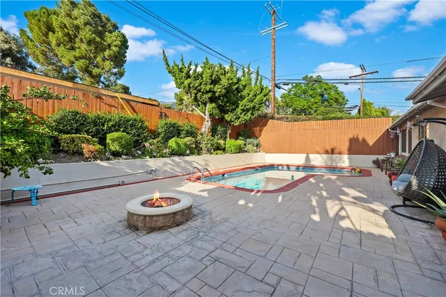 a view of a backyard with sitting area