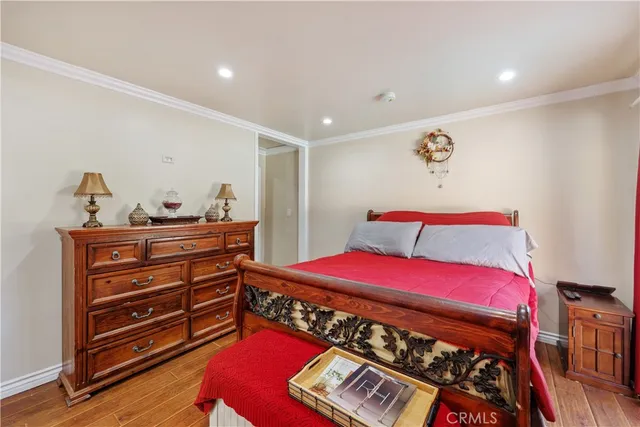 a bedroom with a bed and a dresser in it