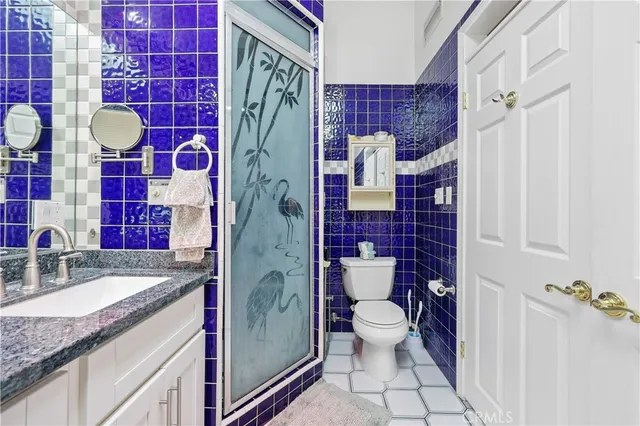 a bathroom with a granite countertop toilet sink and shower