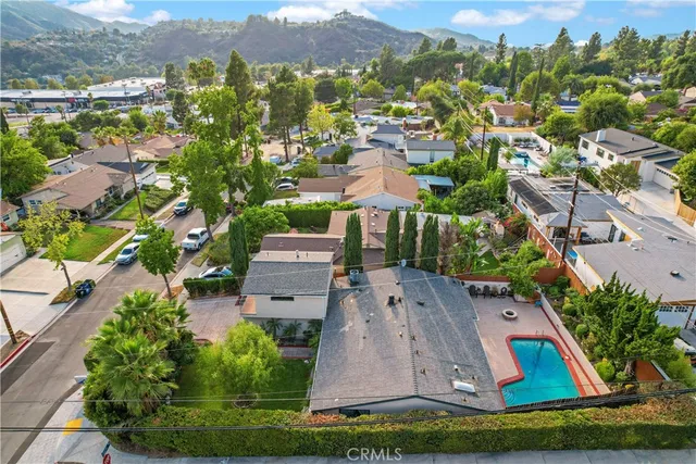 an aerial view of multiple houses with yard