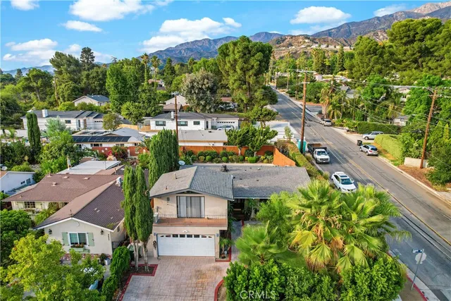 an aerial view of a house with a yard and potted plants