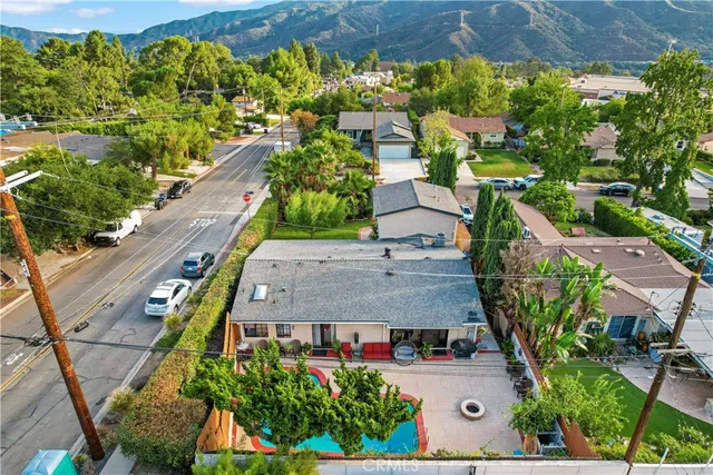 an aerial view of a residential houses with street