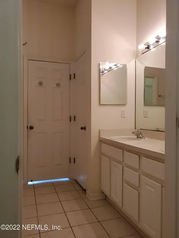 an empty room with a window and a ceiling fan