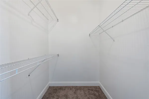 a view of storage and utility room with racks on the wall