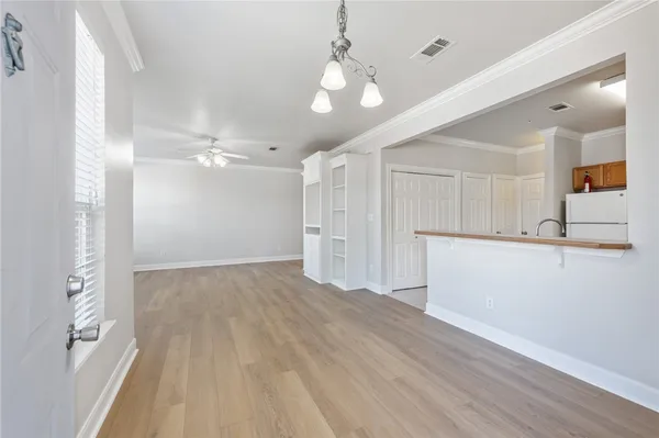 a view of empty room with wooden floor