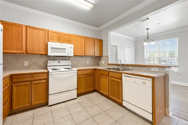 a kitchen with granite countertop cabinets stainless steel appliances and a sink