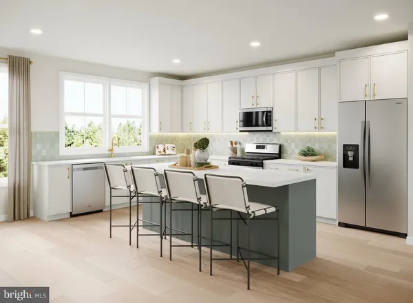 a kitchen with kitchen island granite countertop a sink stove and refrigerator