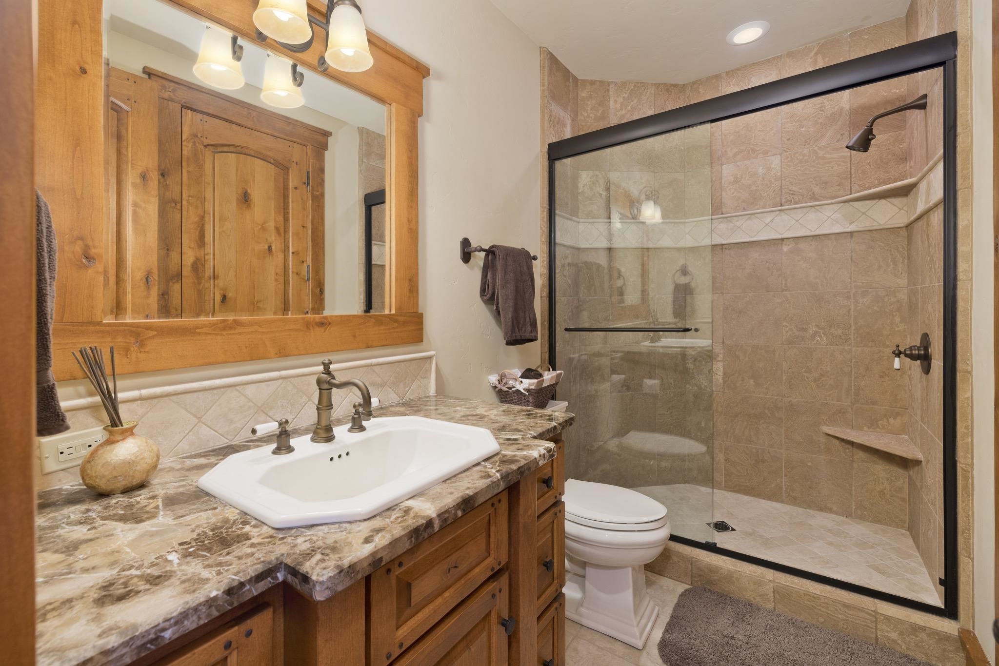 269 Juniper Road Mammoth Lakes, CA 93546 - Photo 41 of 56 a bathroom with a granite countertop sink toilet and shower