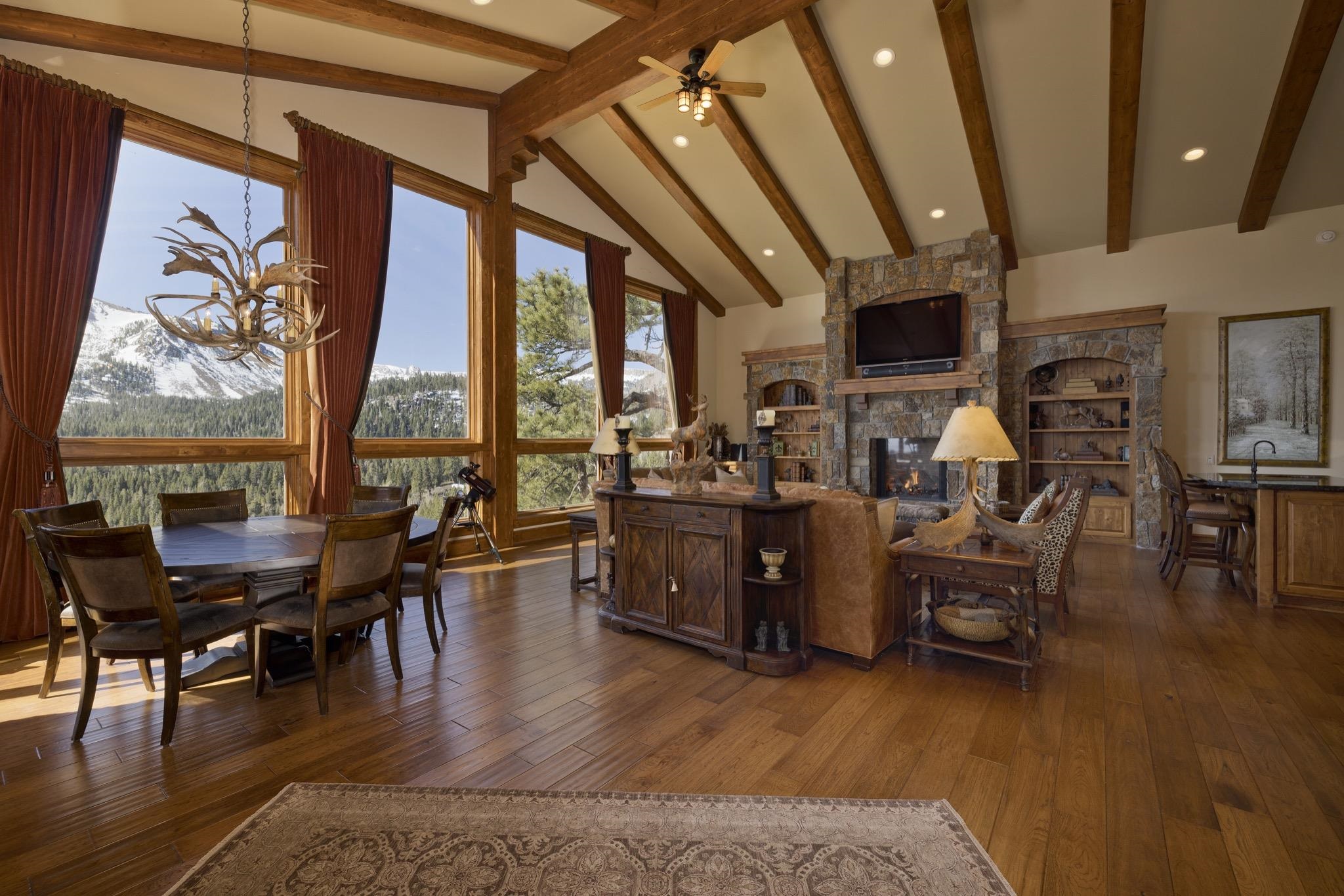 269 Juniper Road Mammoth Lakes, CA 93546 - Photo 6 of 56 a living room with furniture a fireplace and large windows