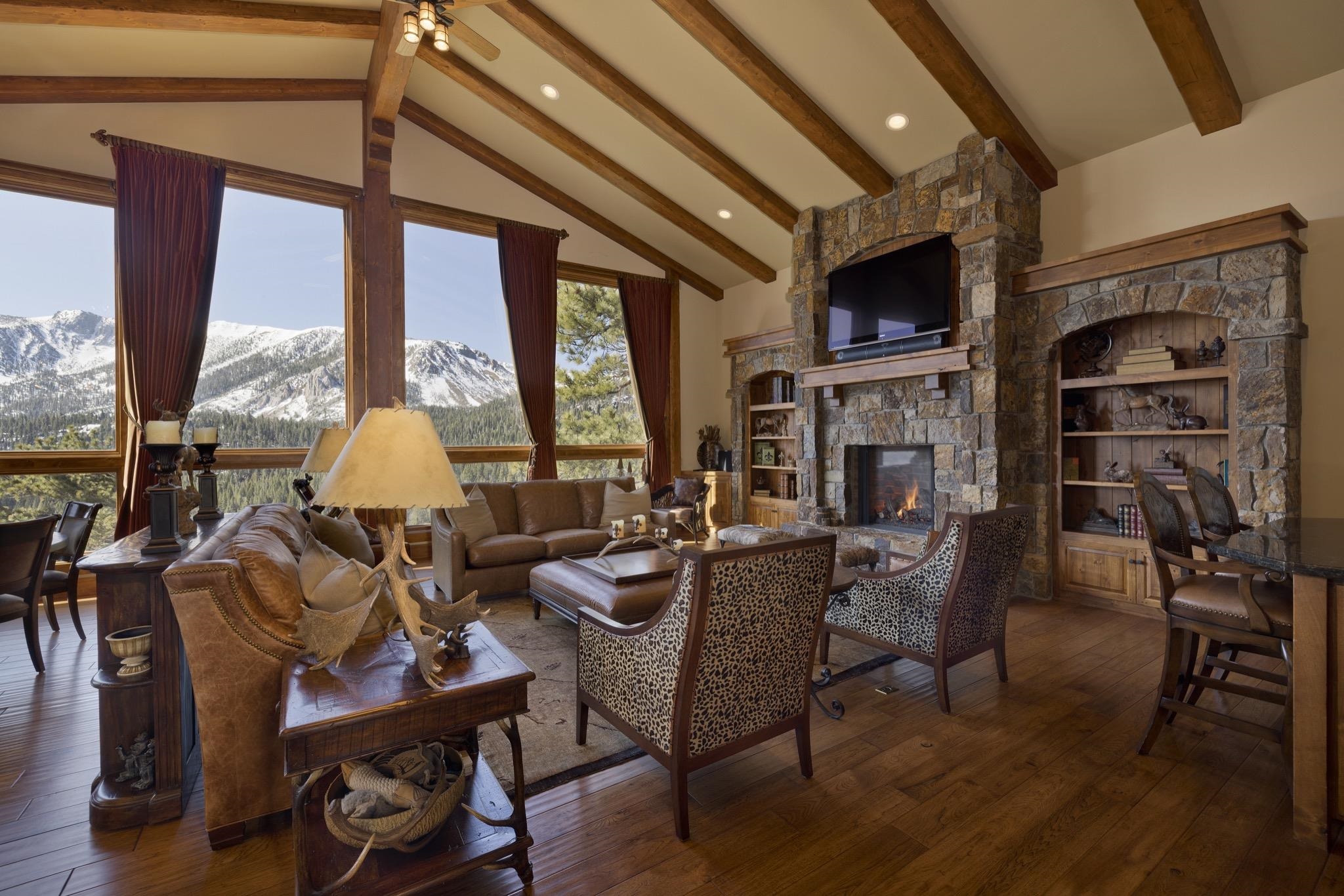 269 Juniper Road Mammoth Lakes, CA 93546 - Photo 7 of 56 a living room with furniture a flat screen tv and a floor to ceiling window