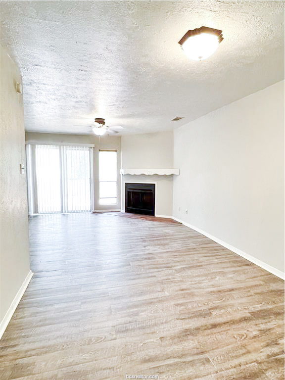 3802 College Main Street, Unit 6 Bryan, TX 77801 - Photo 5 of 12 a view of an empty room with wooden floor and a window