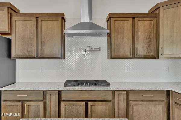 a kitchen with stainless steel appliances granite countertop a refrigerator and a stove