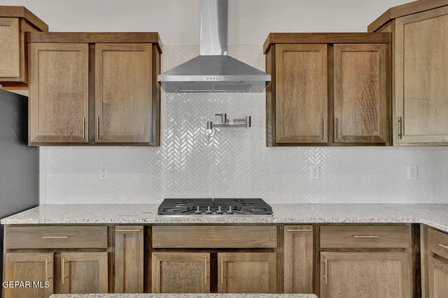 a kitchen with stainless steel appliances granite countertop a refrigerator and a stove