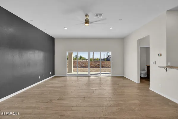 a kitchen with stainless steel appliances a stove top oven a sink and a refrigerator