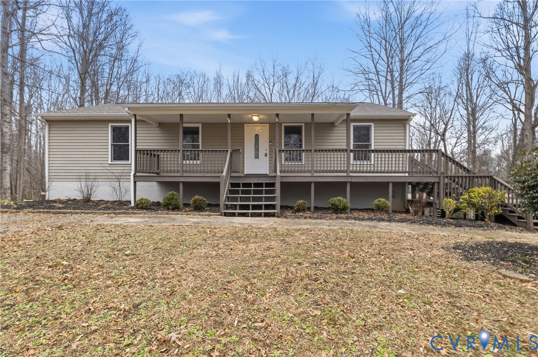 836 Walkerton Road Walkerton, VA 23177 - Photo 1 of 29 a front view of a house with a garden