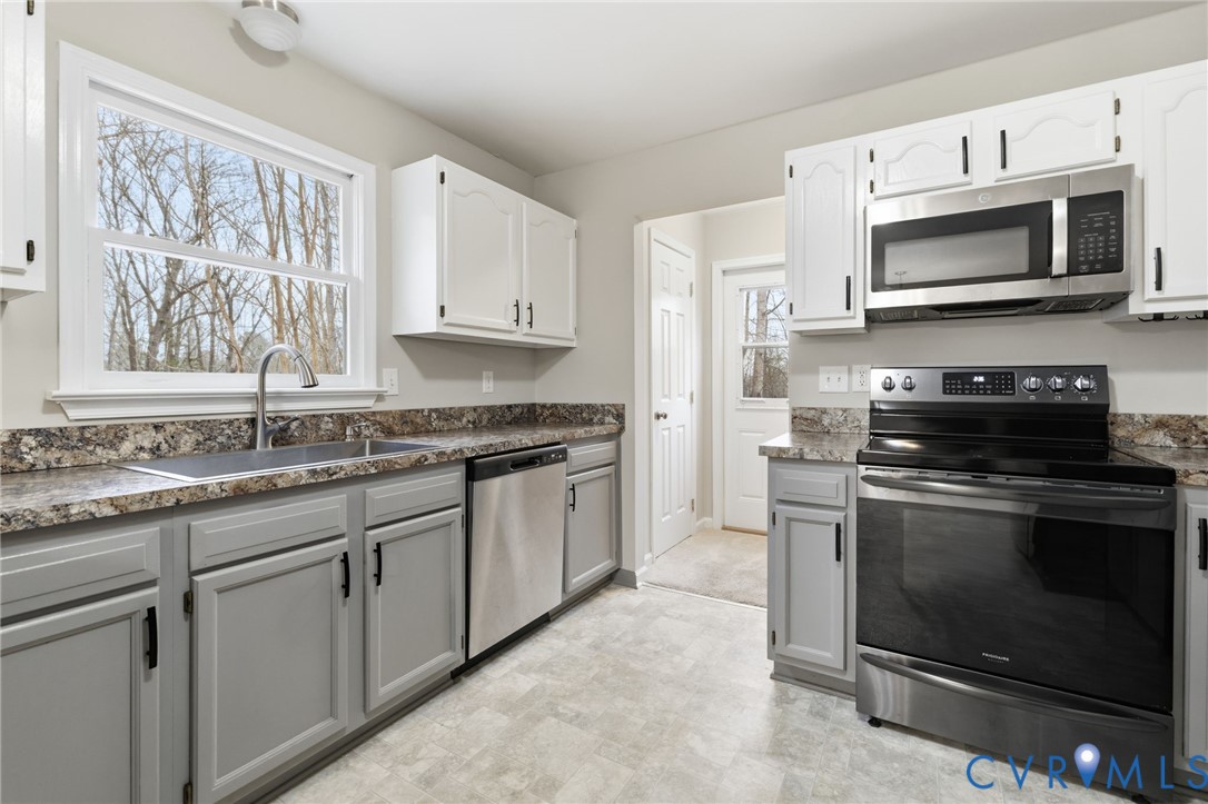 836 Walkerton Road Walkerton, VA 23177 - Photo 12 of 29 a kitchen with granite countertop white cabinets appliances and a sink
