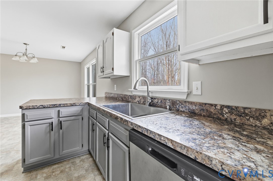 836 Walkerton Road Walkerton, VA 23177 - Photo 14 of 29 a kitchen with granite countertop a sink a stove and cabinets