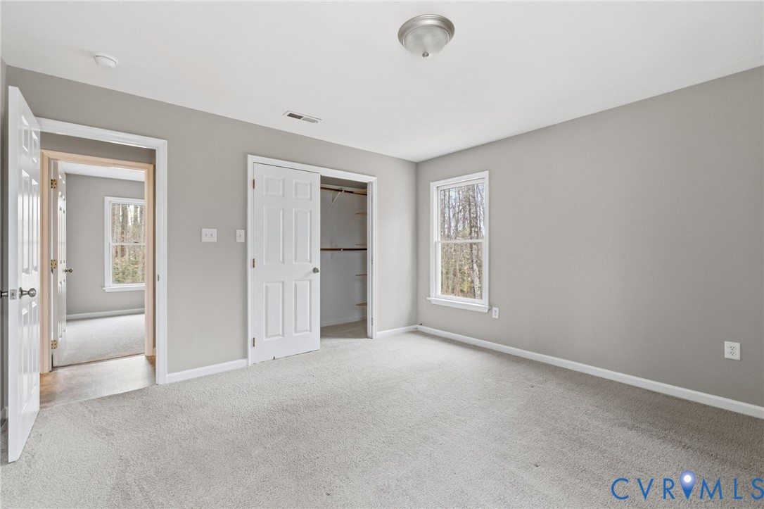 836 Walkerton Road Walkerton, VA 23177 - Photo 19 of 29 an empty room with windows and closet