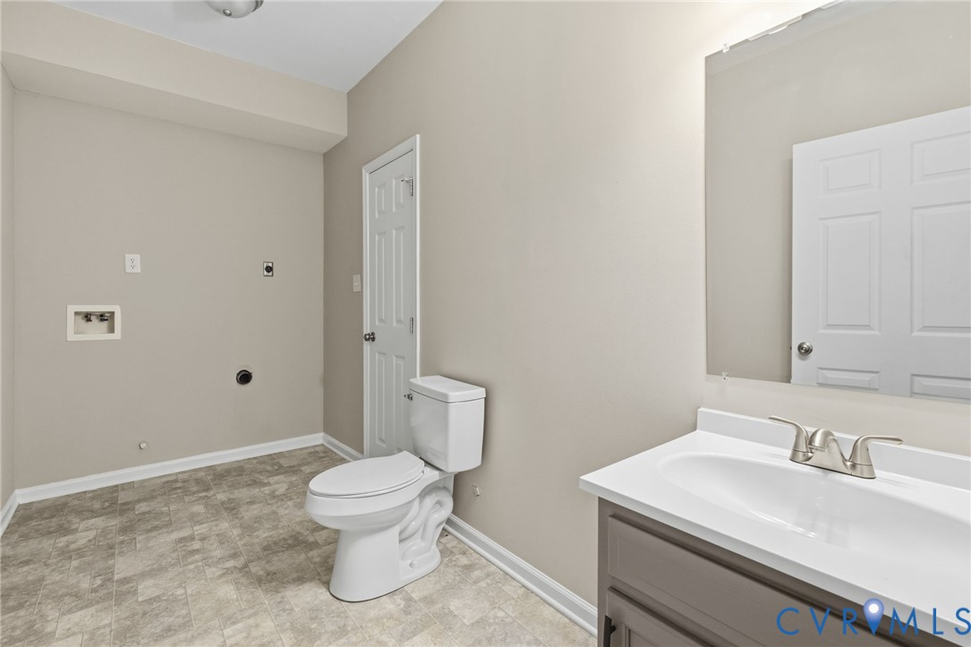 836 Walkerton Road Walkerton, VA 23177 - Photo 23 of 29 a bathroom with a sink a toilet and a mirror