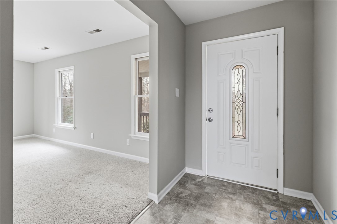 836 Walkerton Road Walkerton, VA 23177 - Photo 4 of 29 an empty room with windows and closet