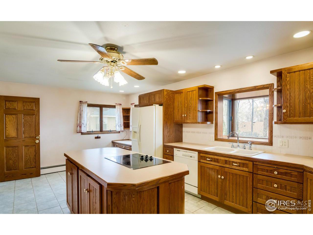 125 West Trilby Road Fort Collins, CO 80525 - Photo 11 of 26 a kitchen with a sink cabinets and window