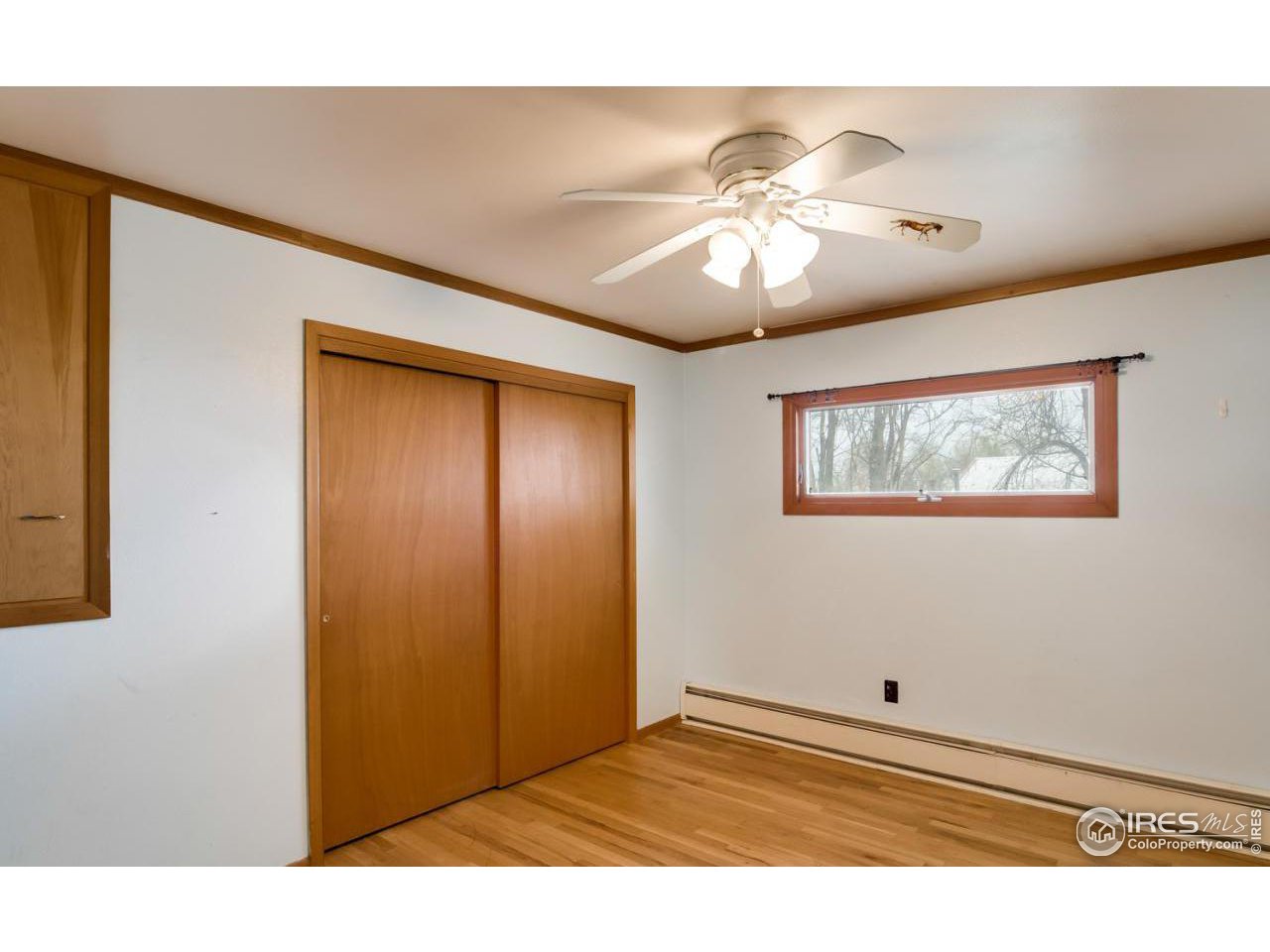 125 West Trilby Road Fort Collins, CO 80525 - Photo 15 of 26 a view of an empty room with wooden floor and a chandelier