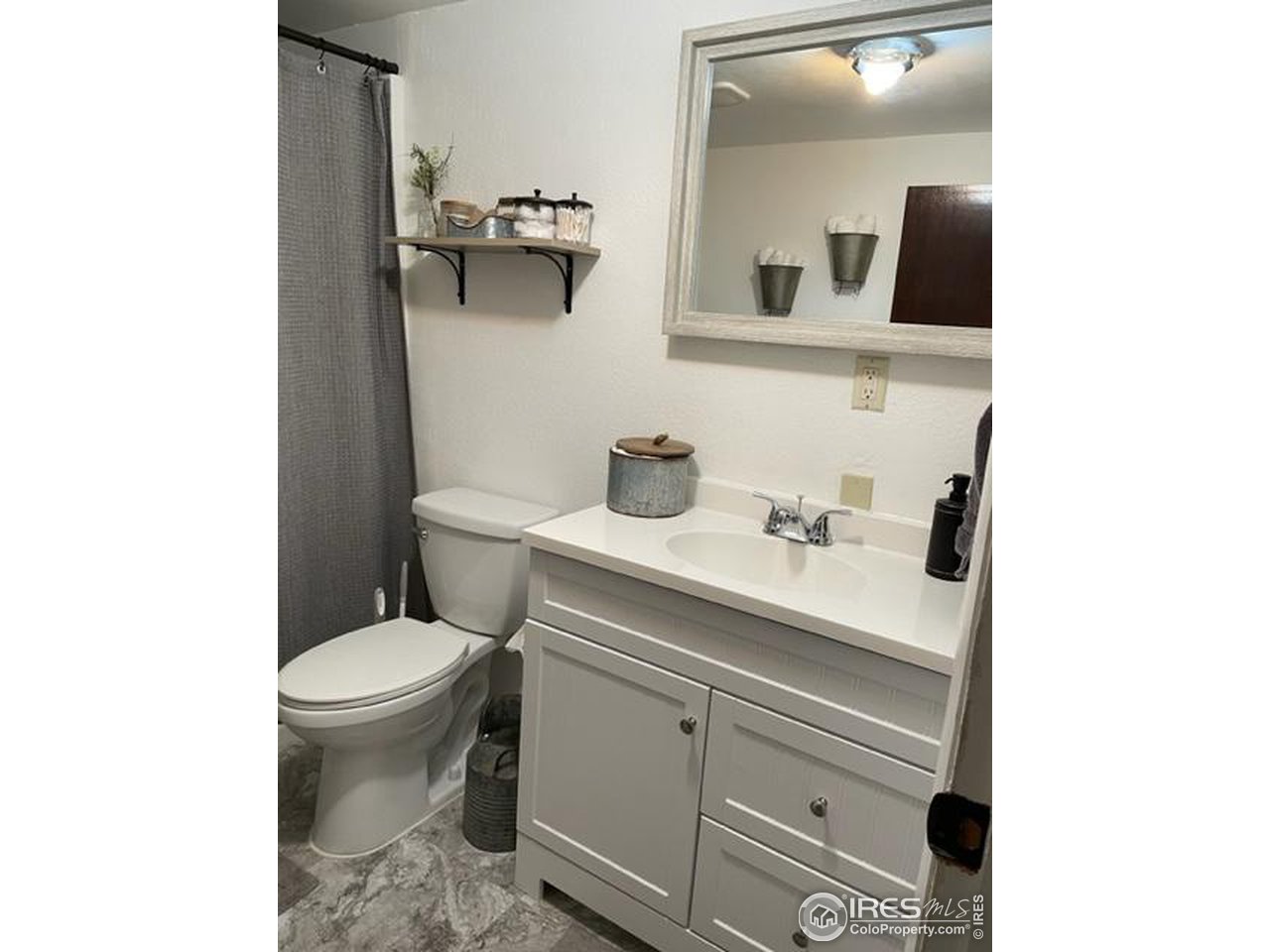 125 West Trilby Road Fort Collins, CO 80525 - Photo 26 of 26 a bathroom with a sink toilet and mirror